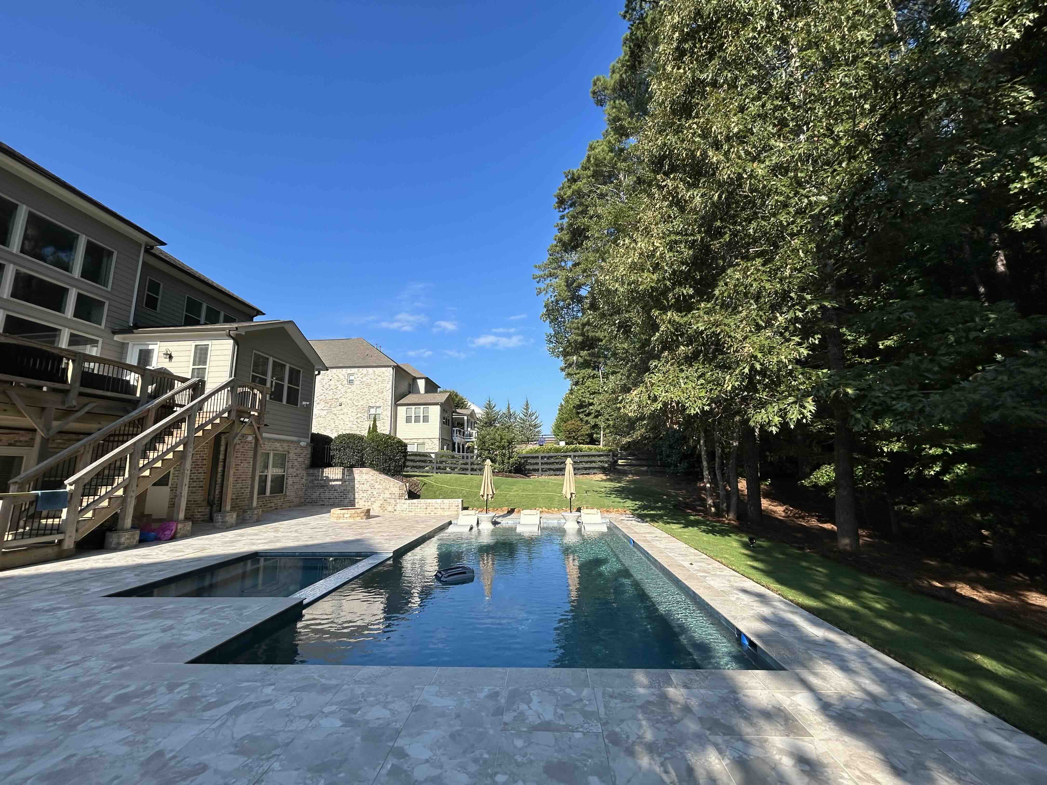 Premium travertine pool decking around a custom geometric pool in Metro Atlanta, GA