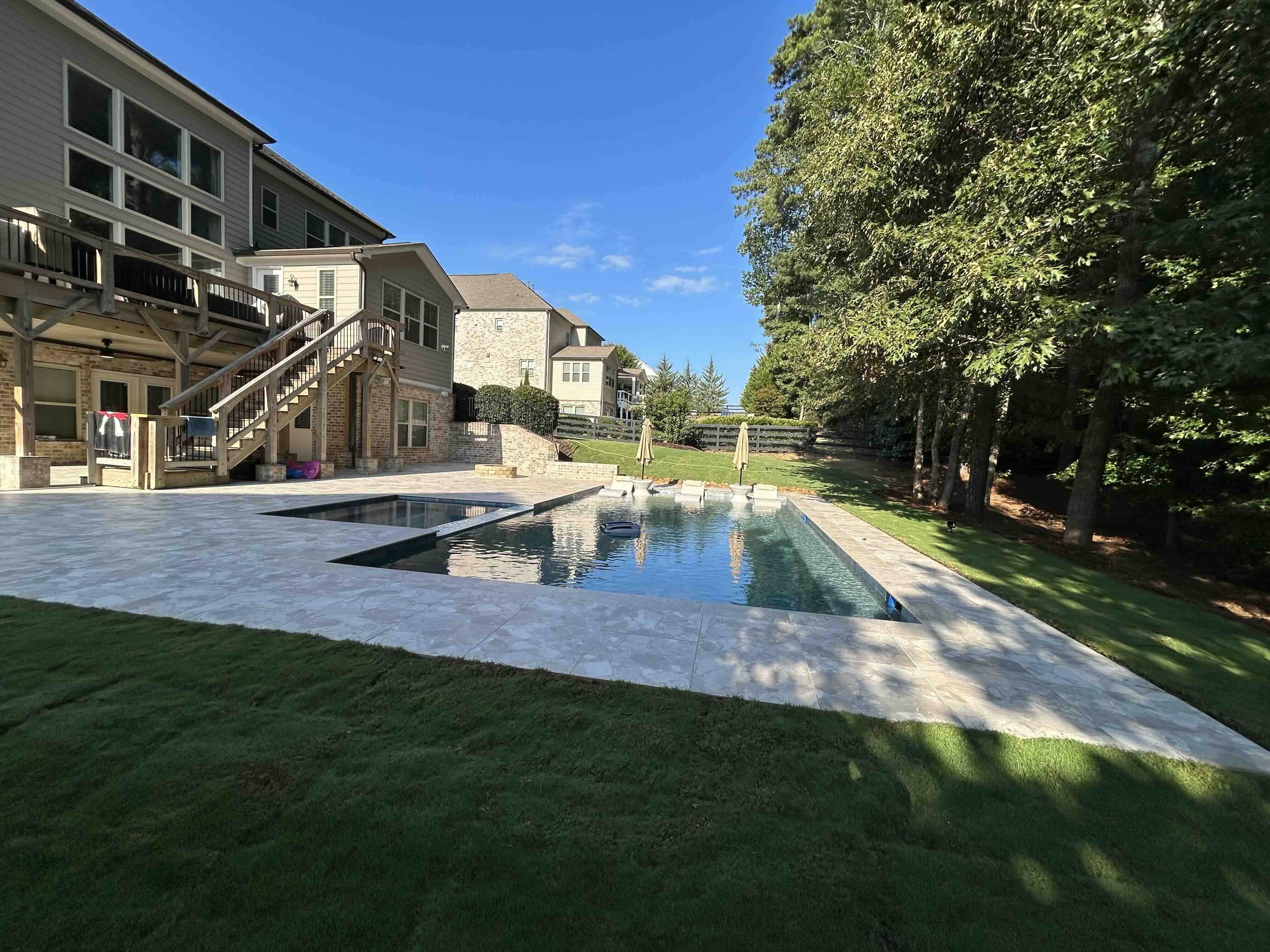 Custom pool with integrated spa spillover water feature and sun shelf in Metro Atlanta, Georgia