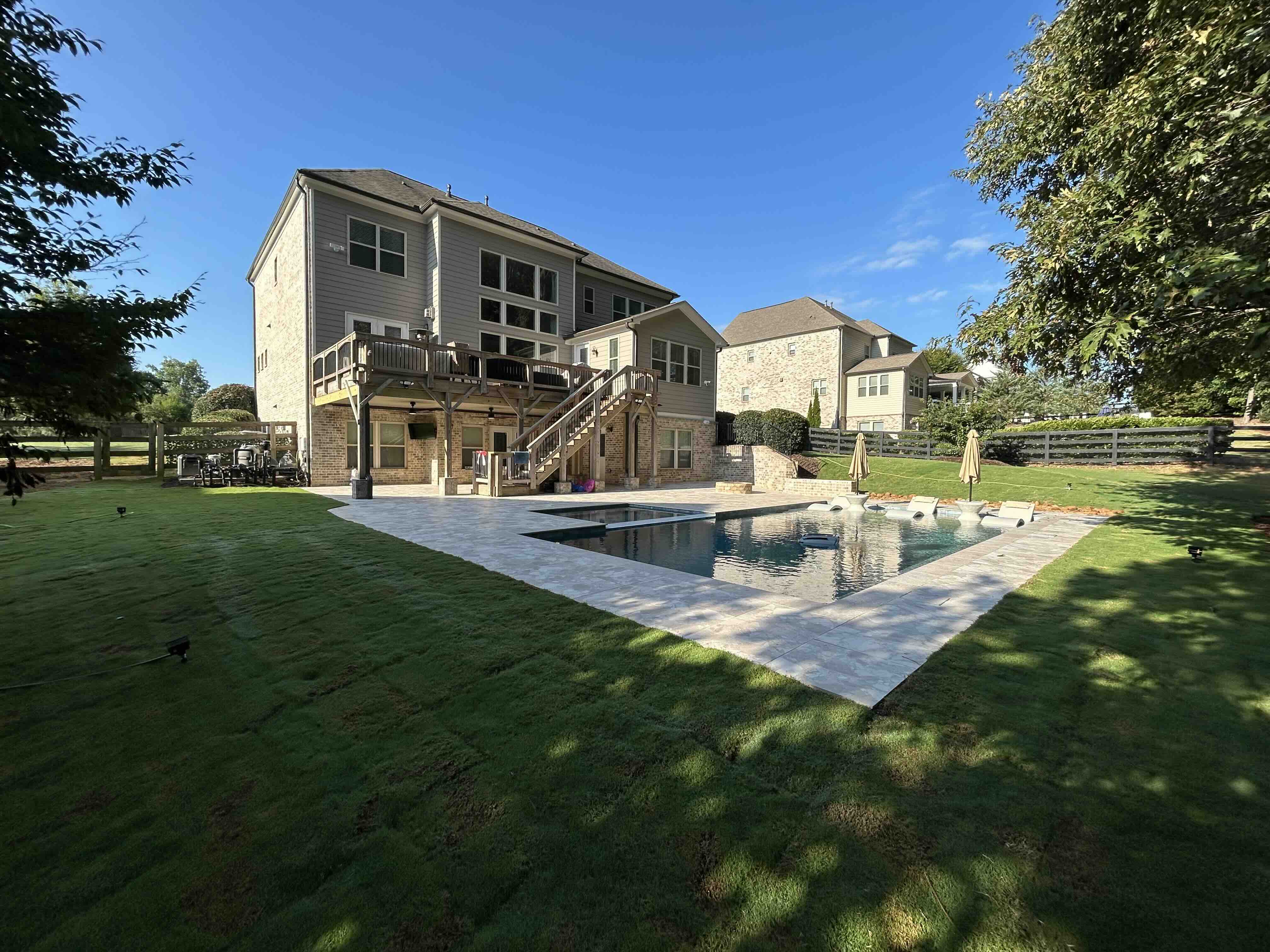 Freshly sodded lawn and landscaping surrounding a new custom pool in Metro Atlanta