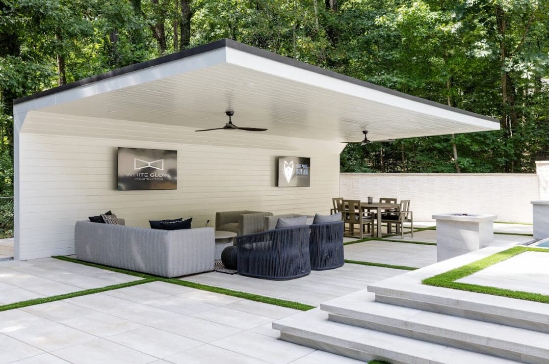 Covered Buckhead pavilion with lounge seating, dining area, and broad poolside steps