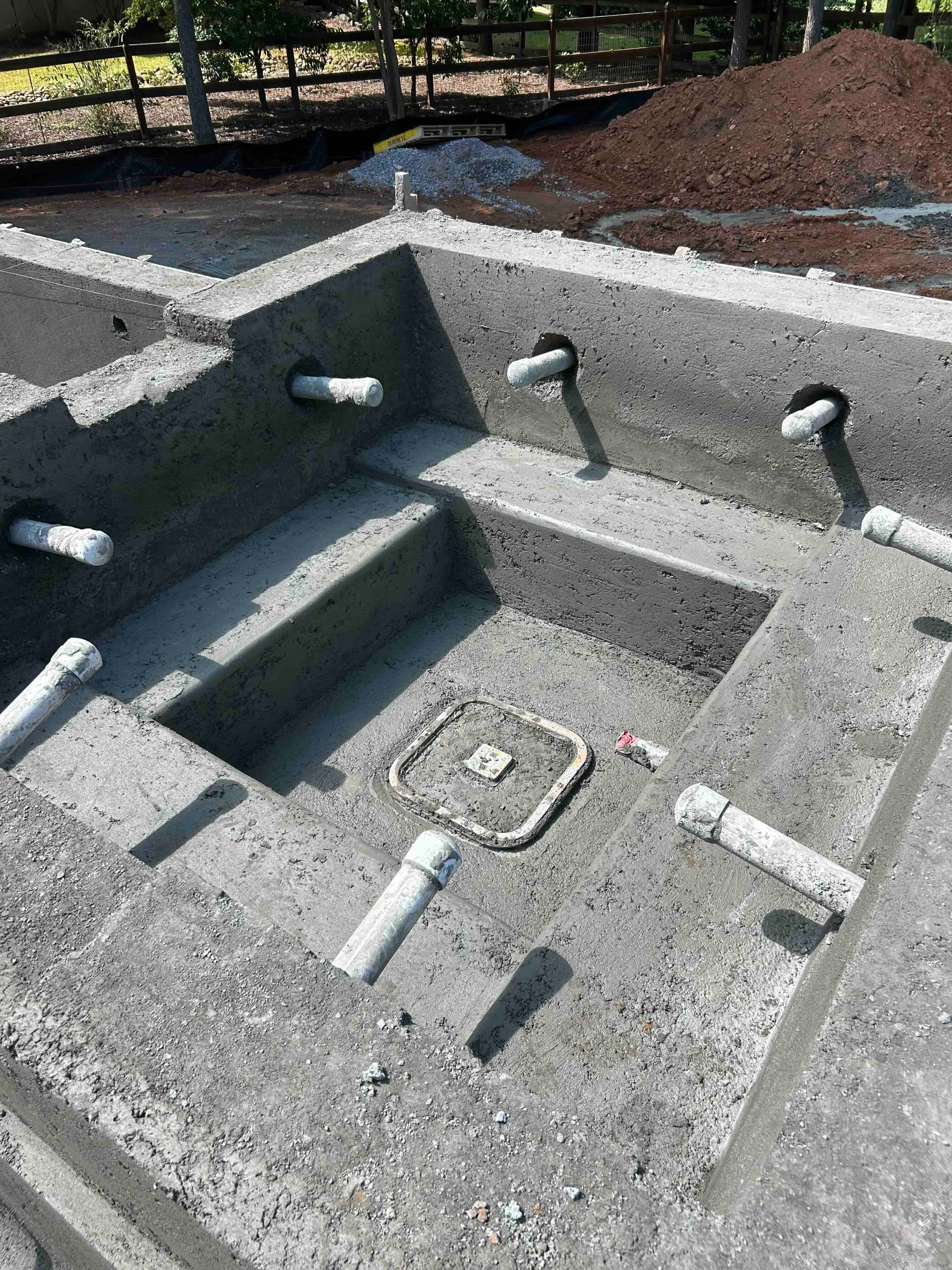 Close view of the raised spa structure and plumbing fittings.