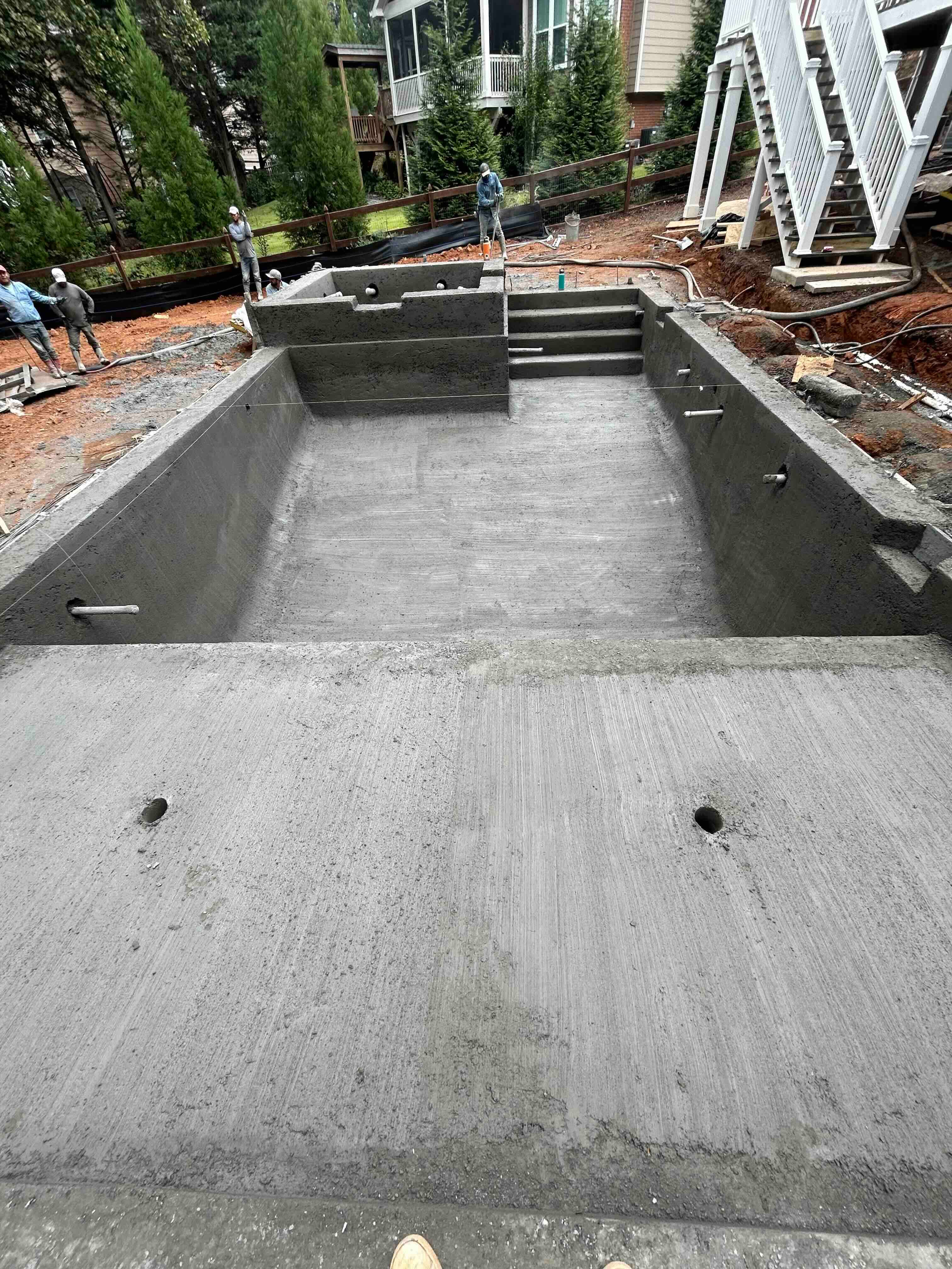 Looking down the new pool shell toward its entry steps.